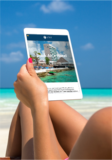 Woman using her tablet on the beach